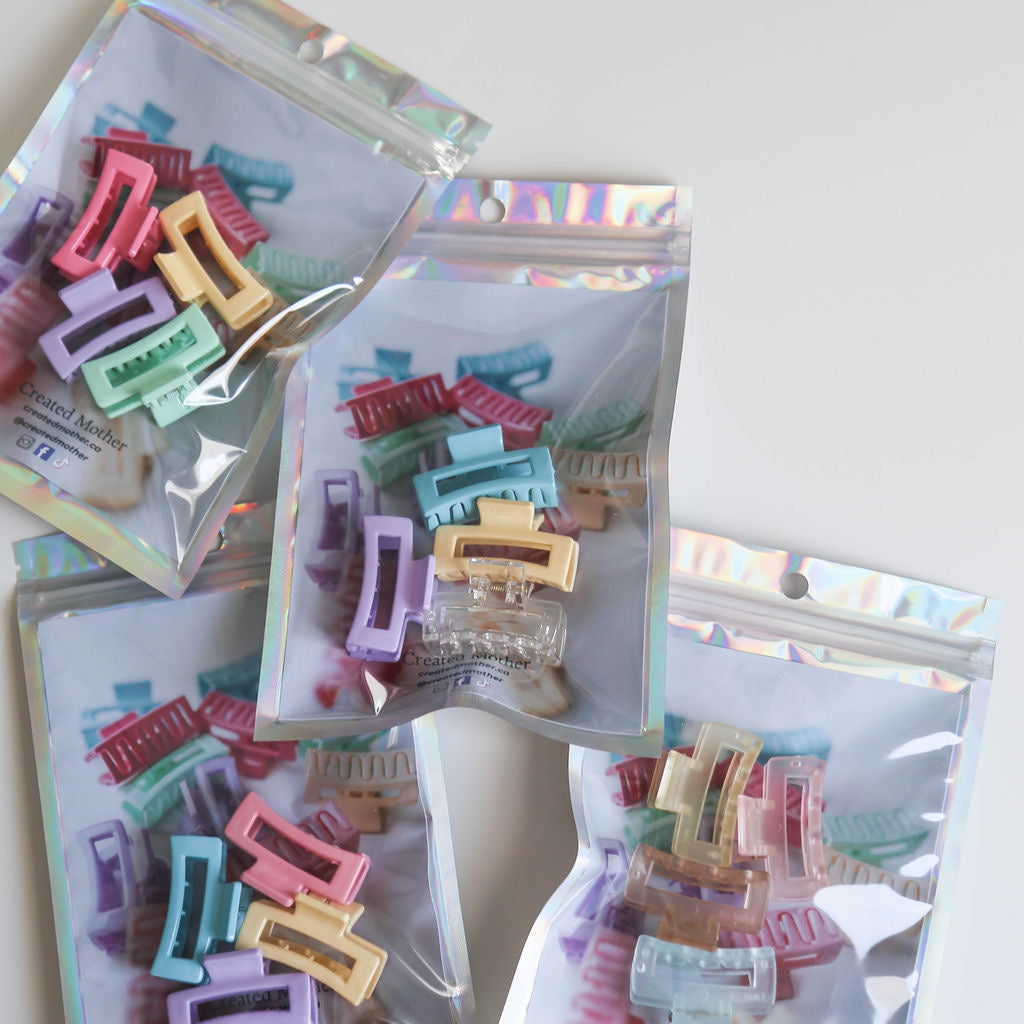 Soft yellow, light blue, and gentle orange claw clips for whimsical hairstyles.