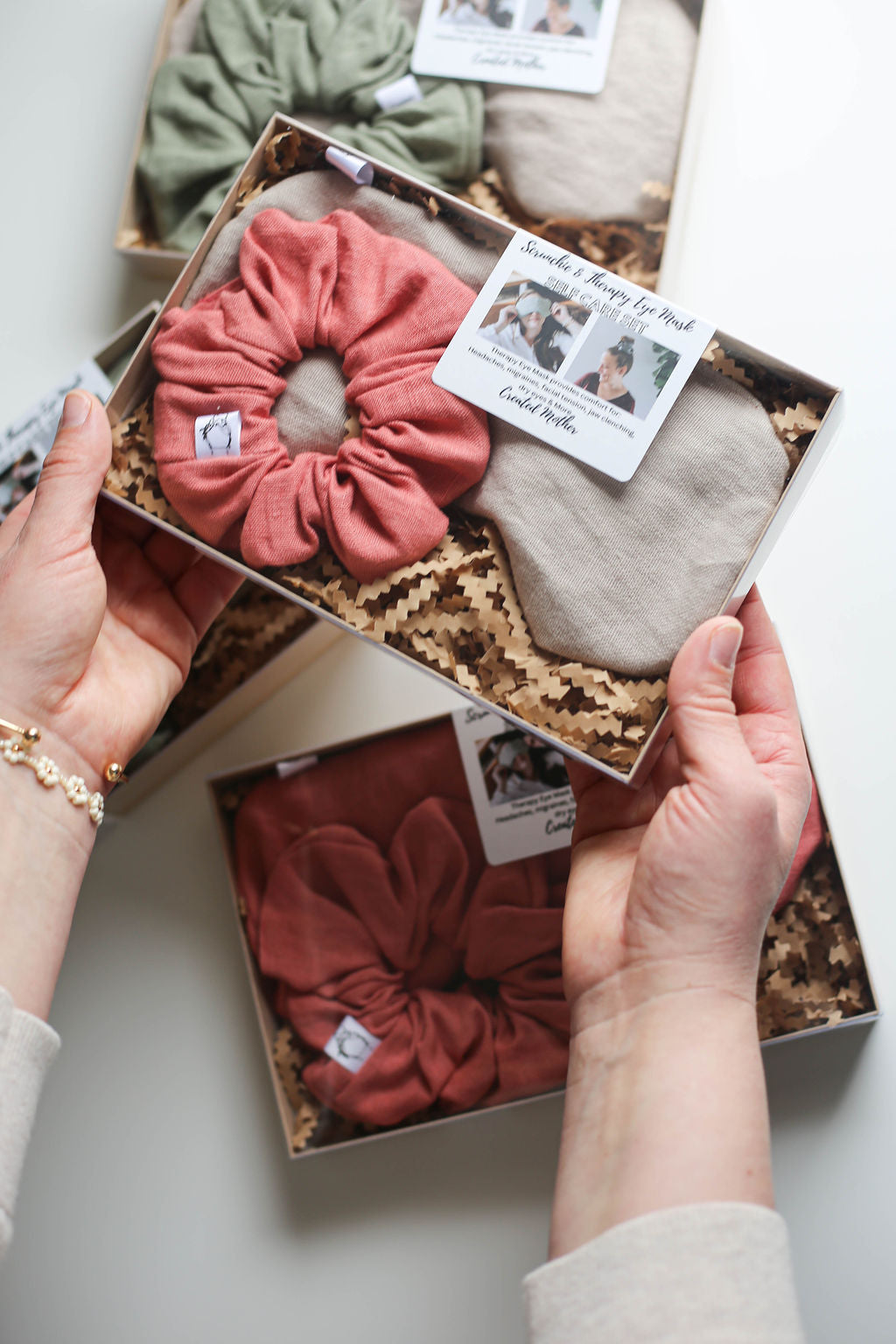 Gift-ready packaging of self-care set with labeled box tag and soft neutral fabric textures inside.