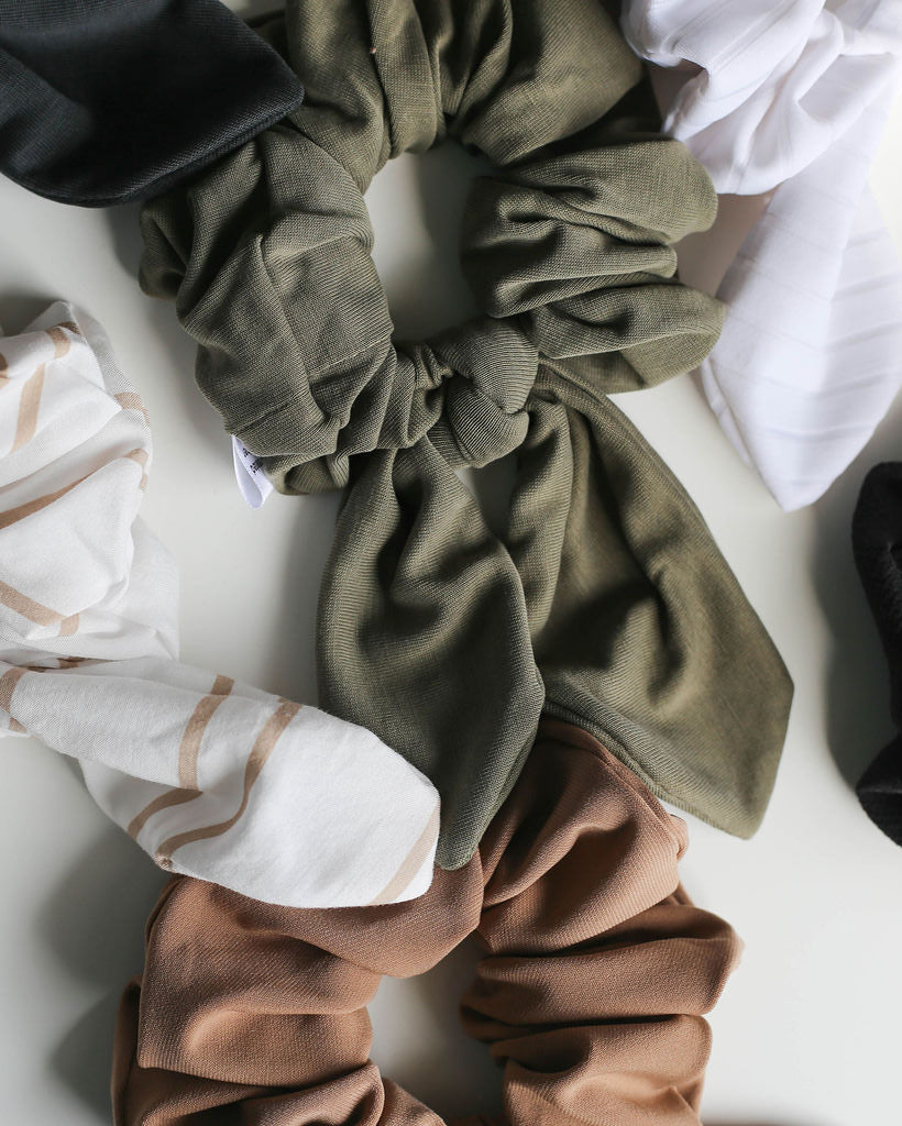 Collection of various colored scrunchies on a light background