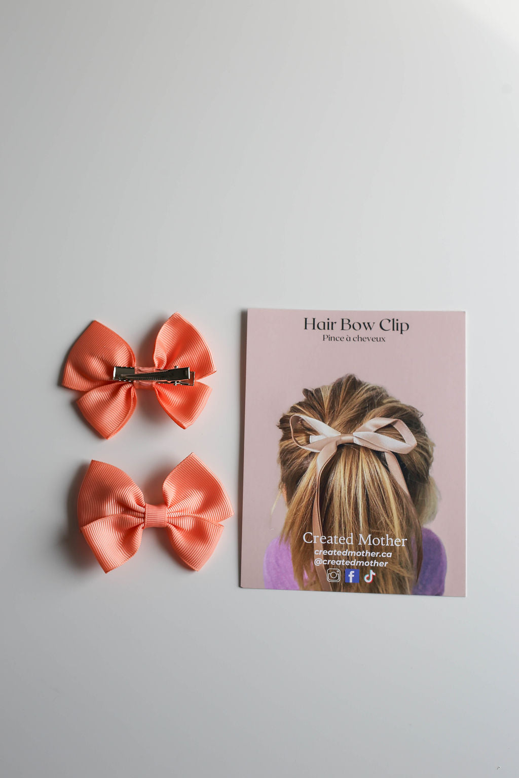 ribbon bow on a metal clip, suitable for both school and special events.