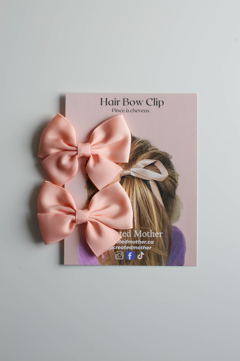 Durable and stylish ribbon bow insofar peach, ideal for holiday or party looks.