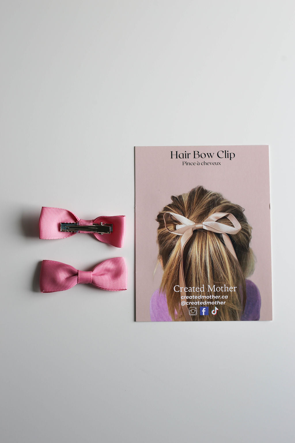 Two pink ribbon bows on metal alligator clips, ideal for everyday wear or events.
