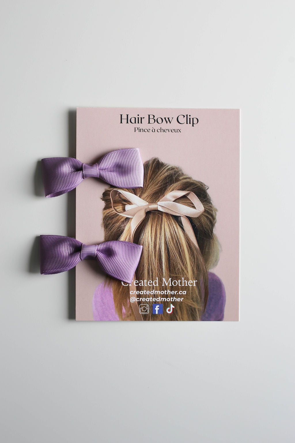 Pair of vibrant purple bow clips with 2.5” alligator clips for a secure, no-slip hold.