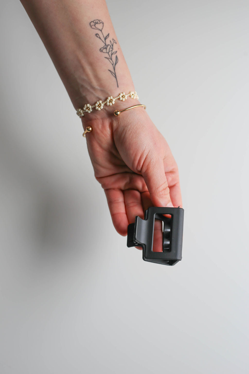 Close-up of matte finish square hair claw in black, highlighting minimalist design.