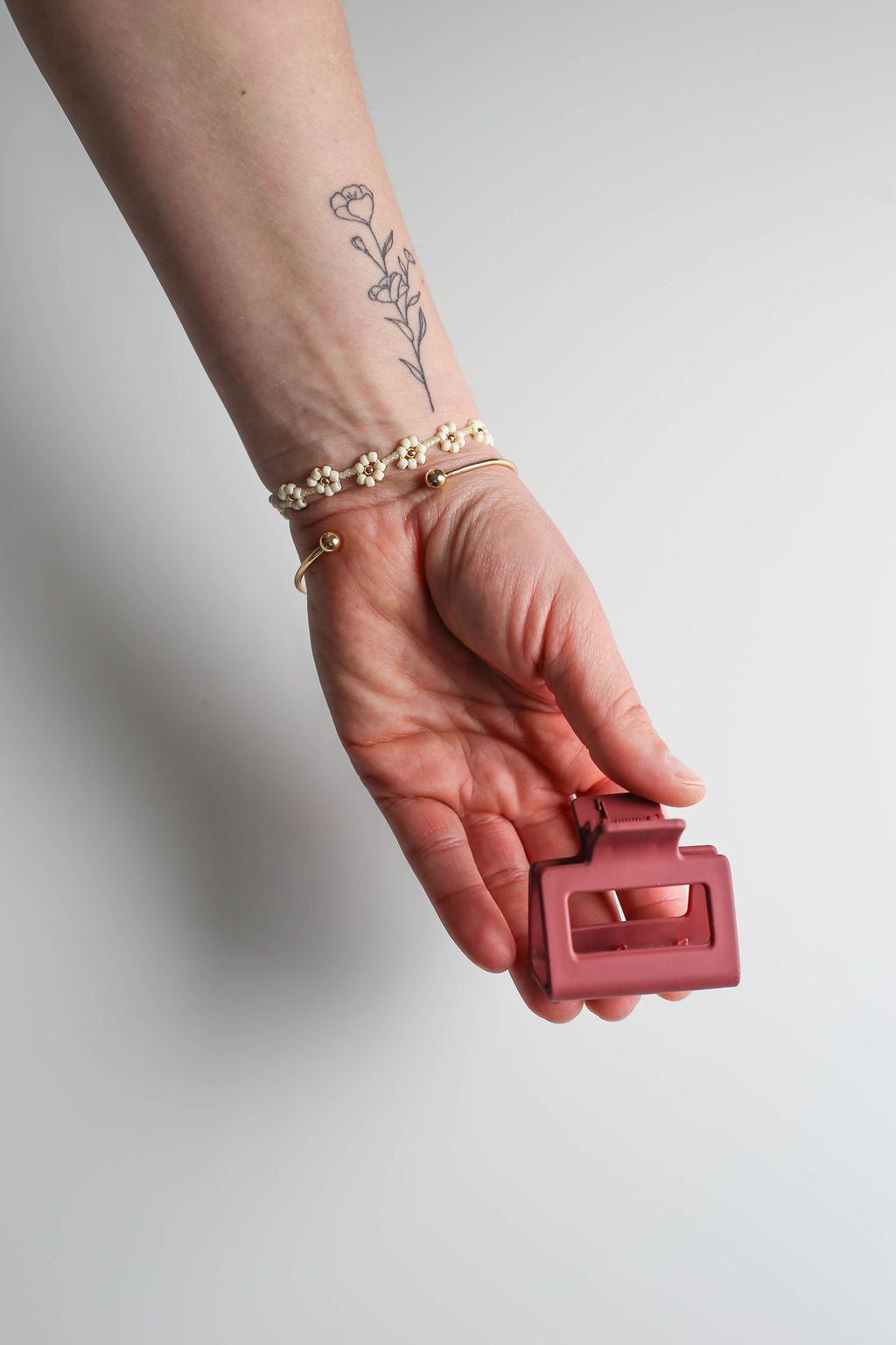 Durable small hair claw shown in a simple, functional hairstyle for work.