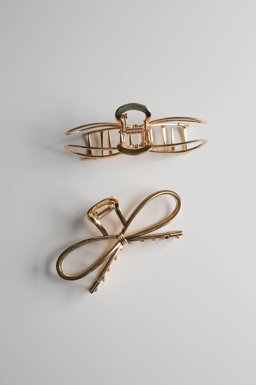 Gold bow claw clip for secure everyday or formal hairstyles.