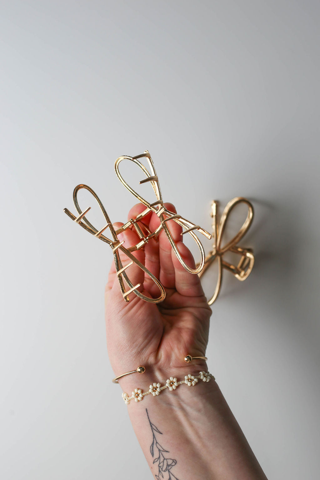 Vintage-inspired metal bow hair clip for elegant updos.