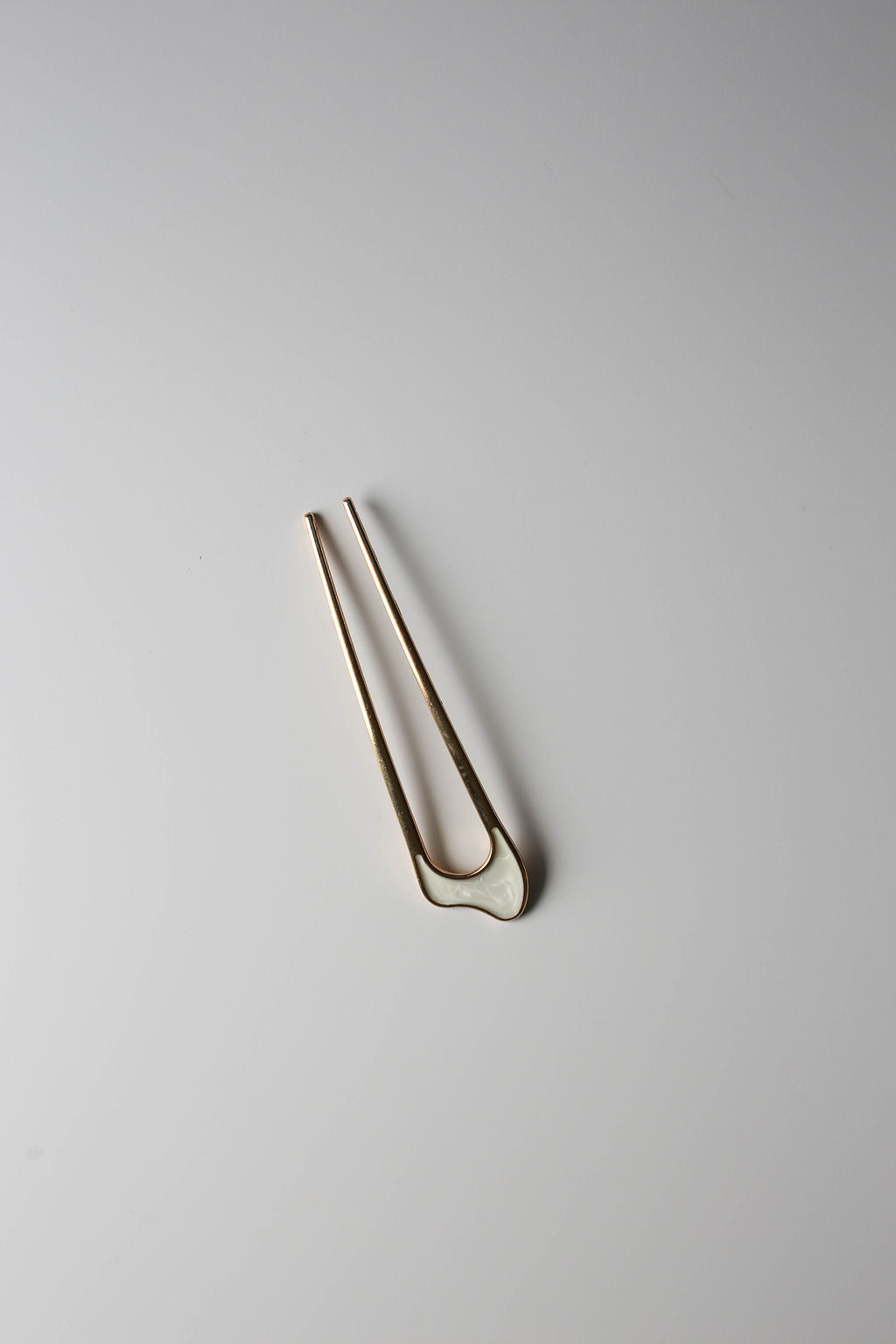 Elegant hair pin for updos, featuring opalescent inlay.