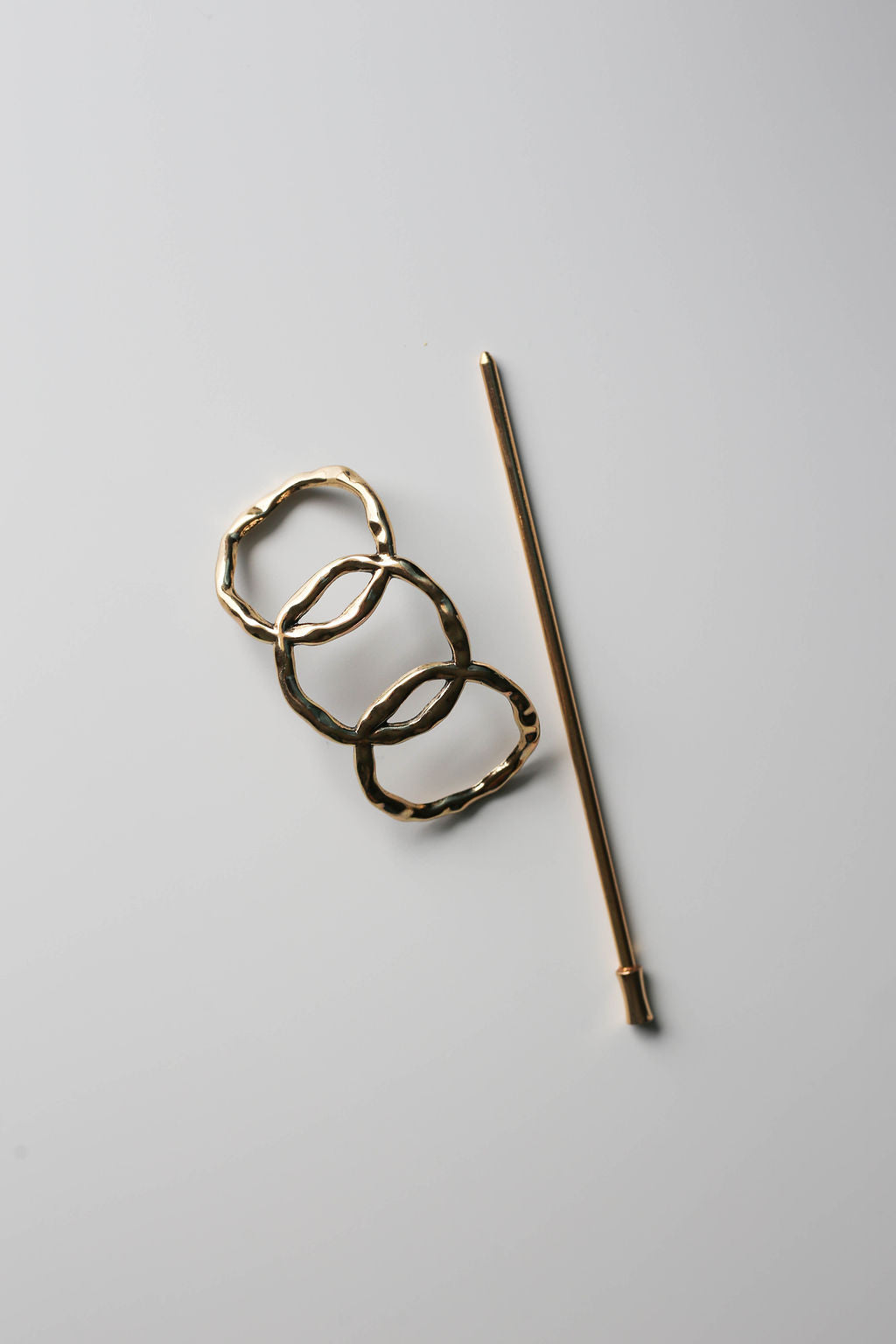 Minimalist geometric gold hair pin for everyday wear.
