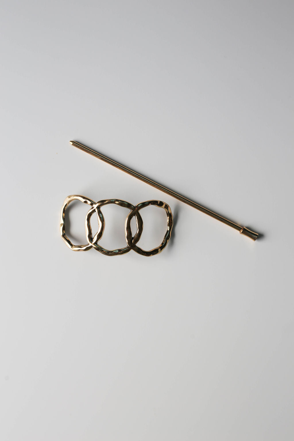 Gold triple-circle vintage style hair pin with hammered detail.