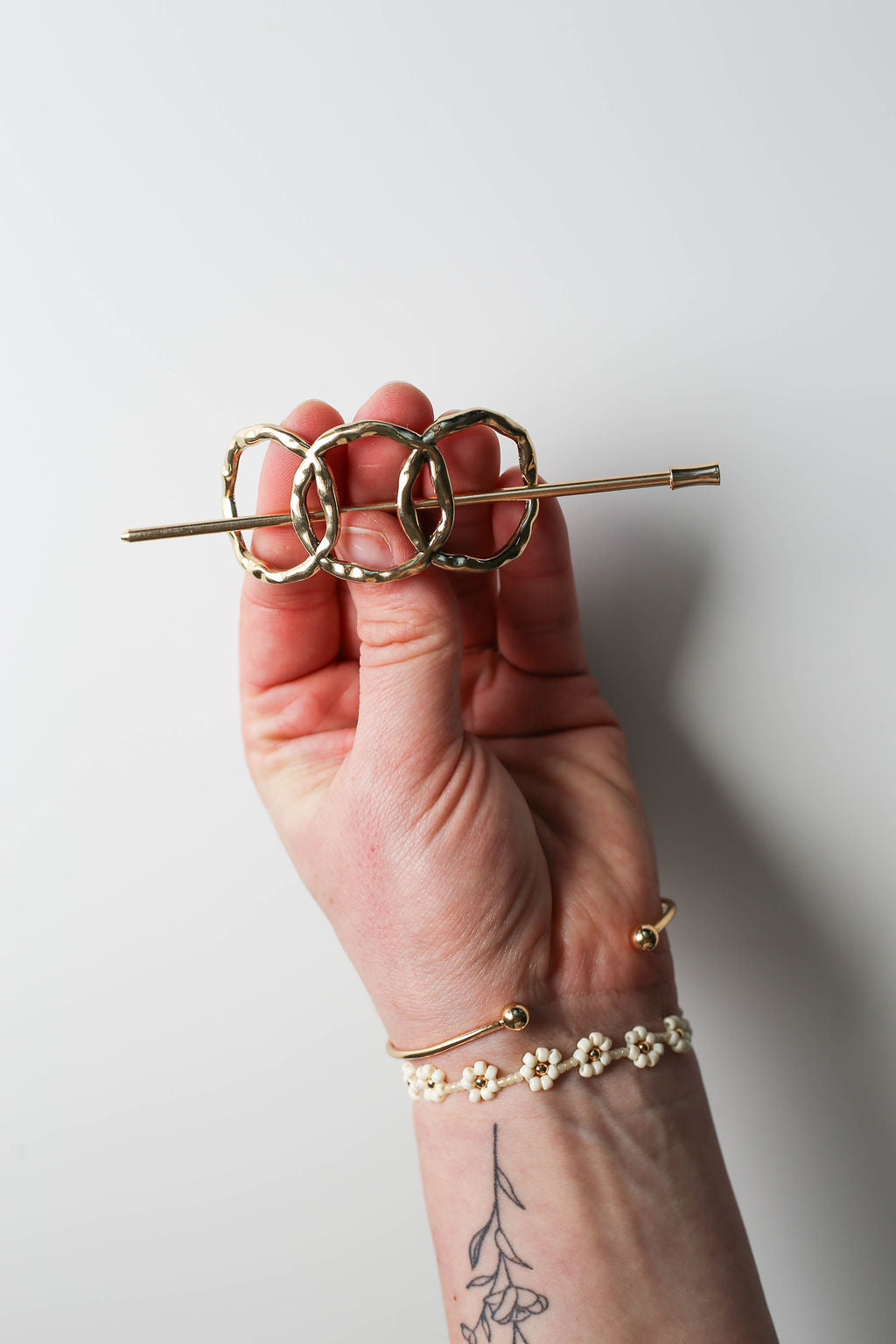 Elegant gold hair accessory with stick closure for secure styling.