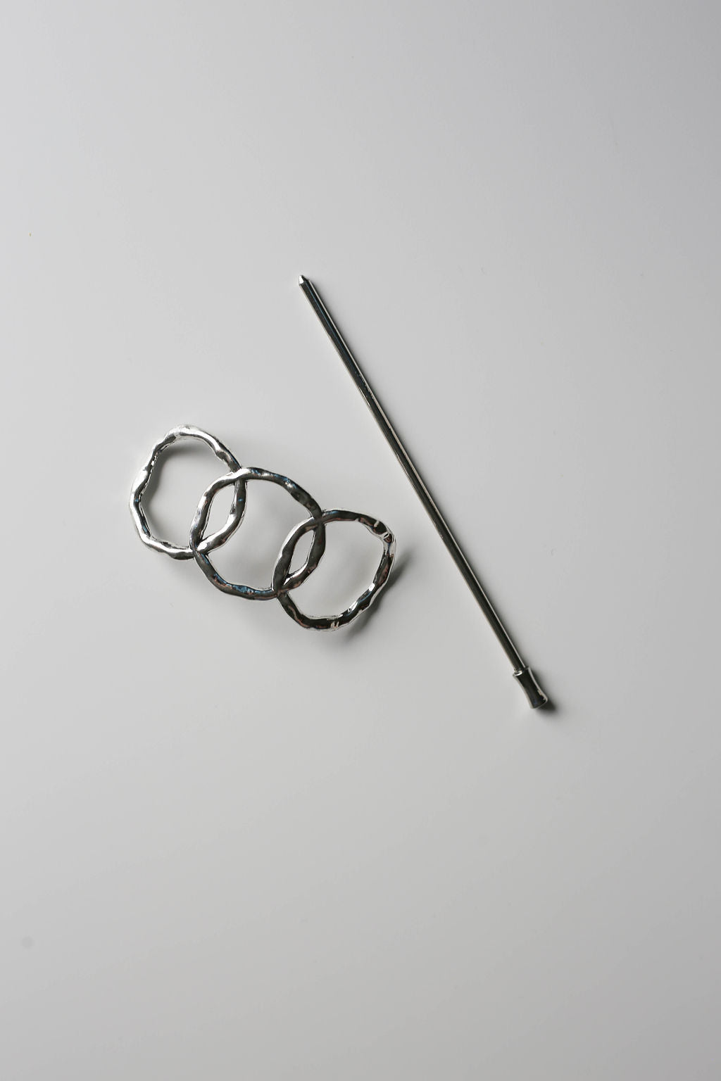 Silver triple-circle vintage style hair pin with sleek stick closure.