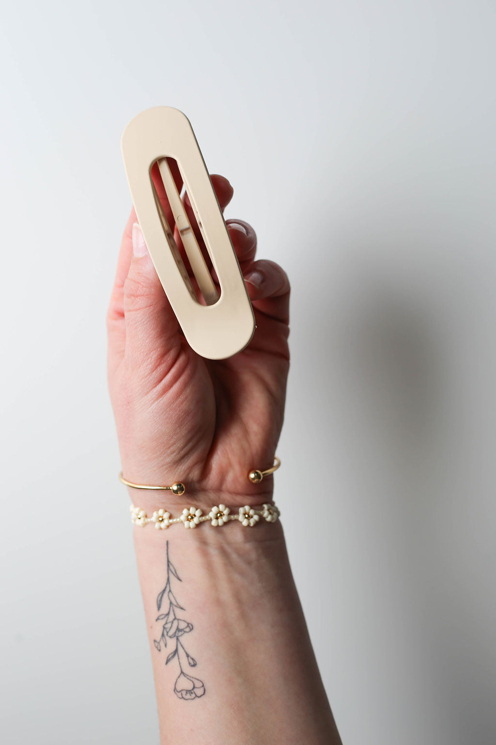 Sleek neutral-tone hair clip with modern, compact design