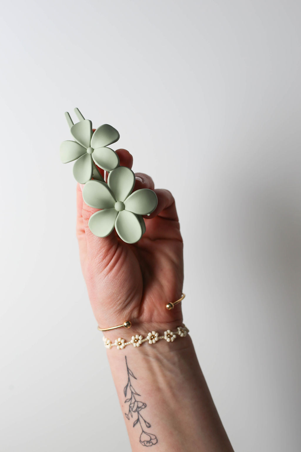 Soft sage green lay flat flower claw clip for yoga and lounging