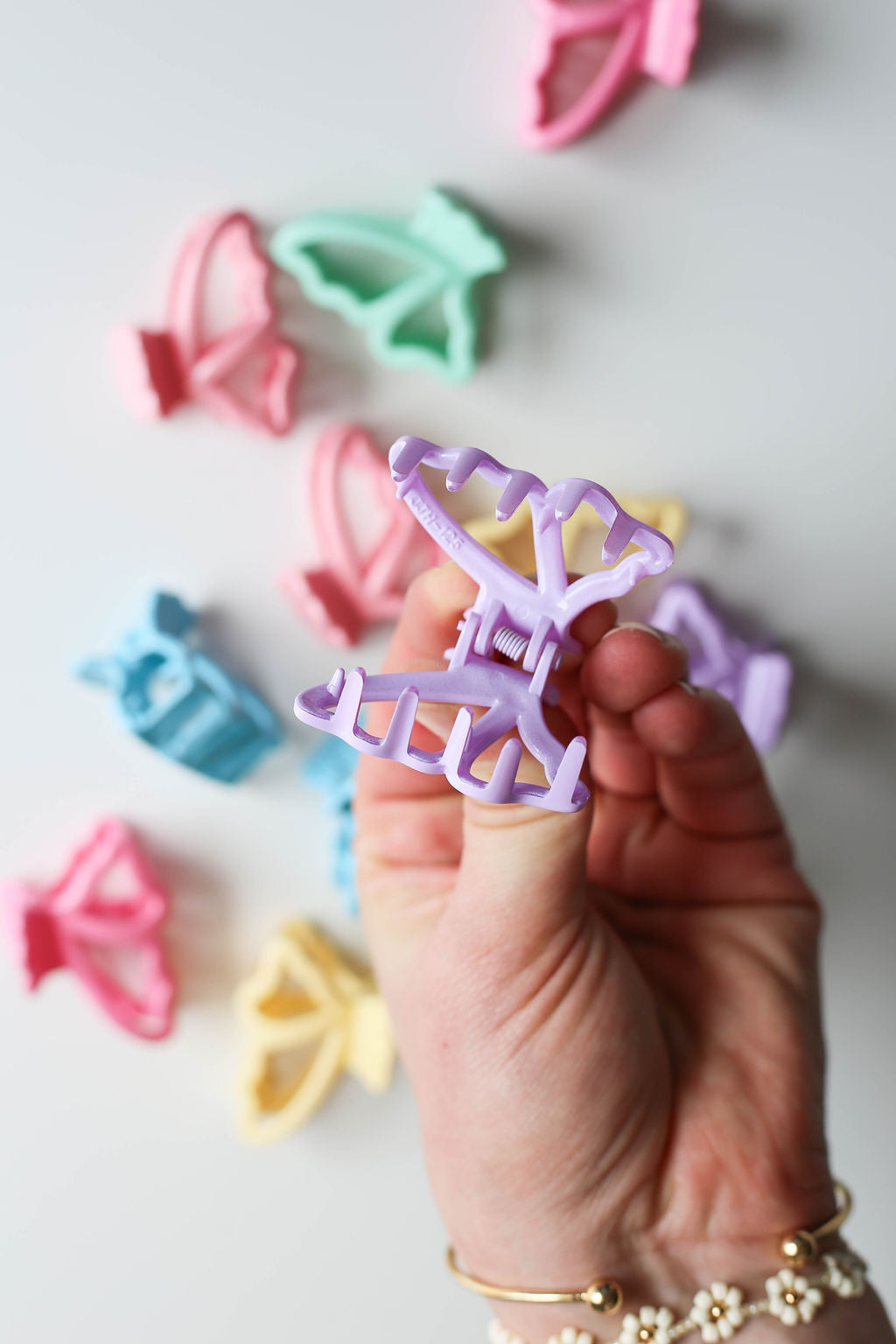 Close-up of butterfly micro clips ideal for adults and kids, offering gentle hair hold