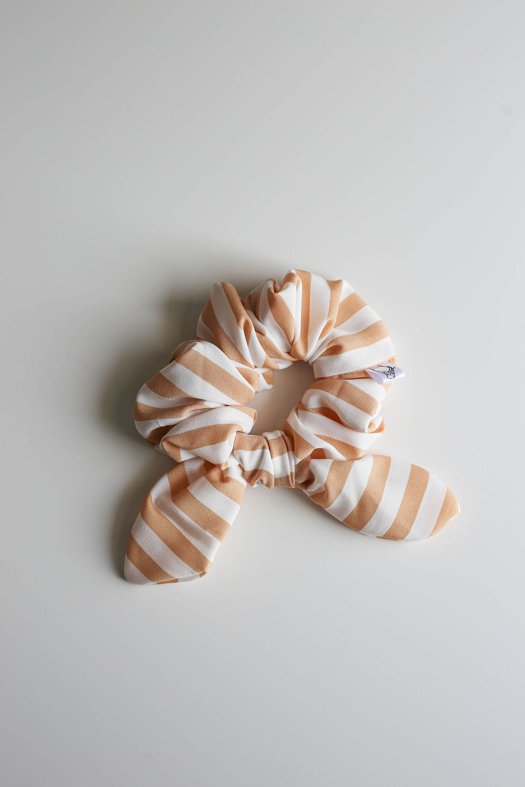 Striped scrunchie on a light gray background