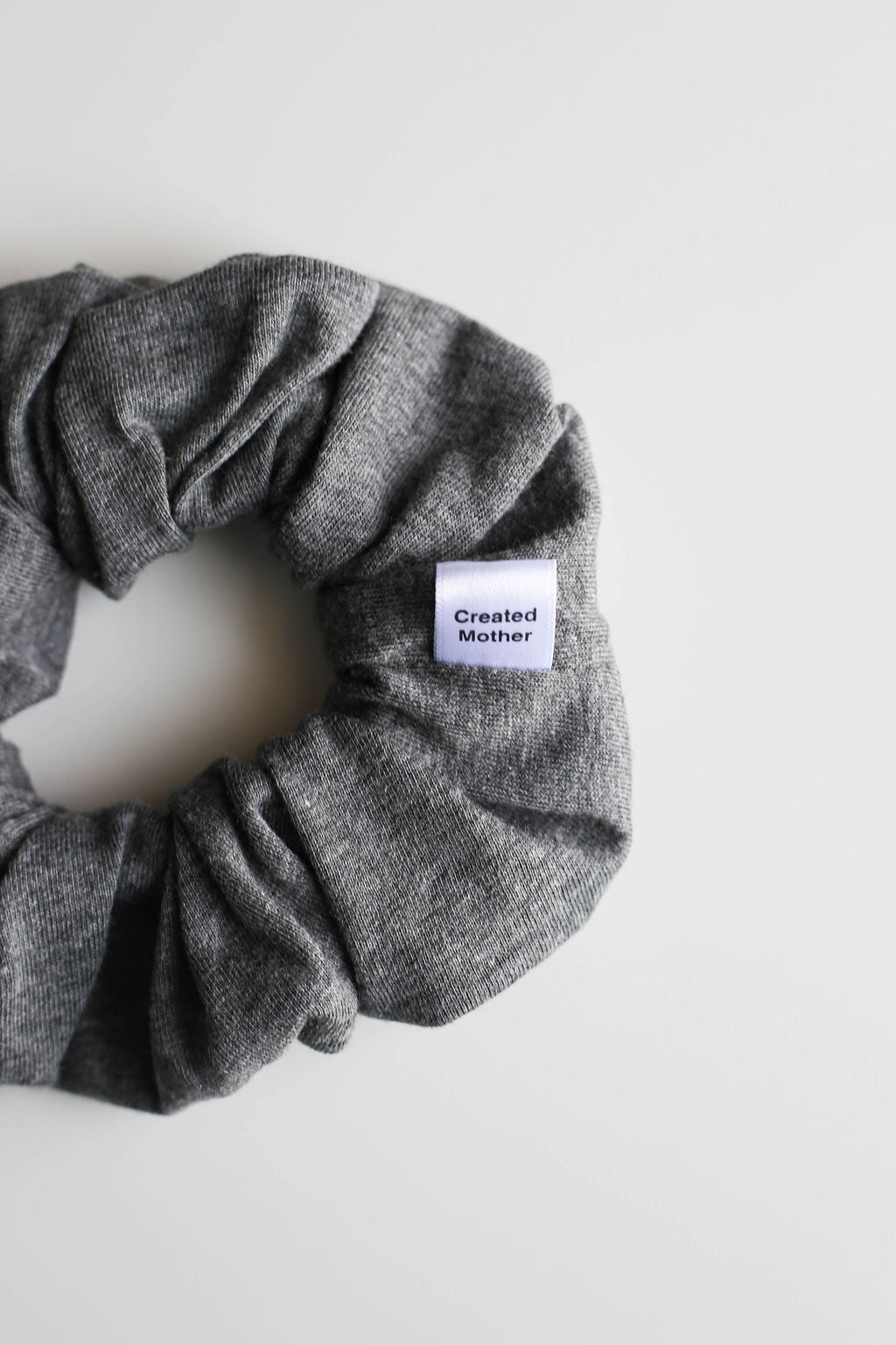 Gray scrunchie with a label on a white background