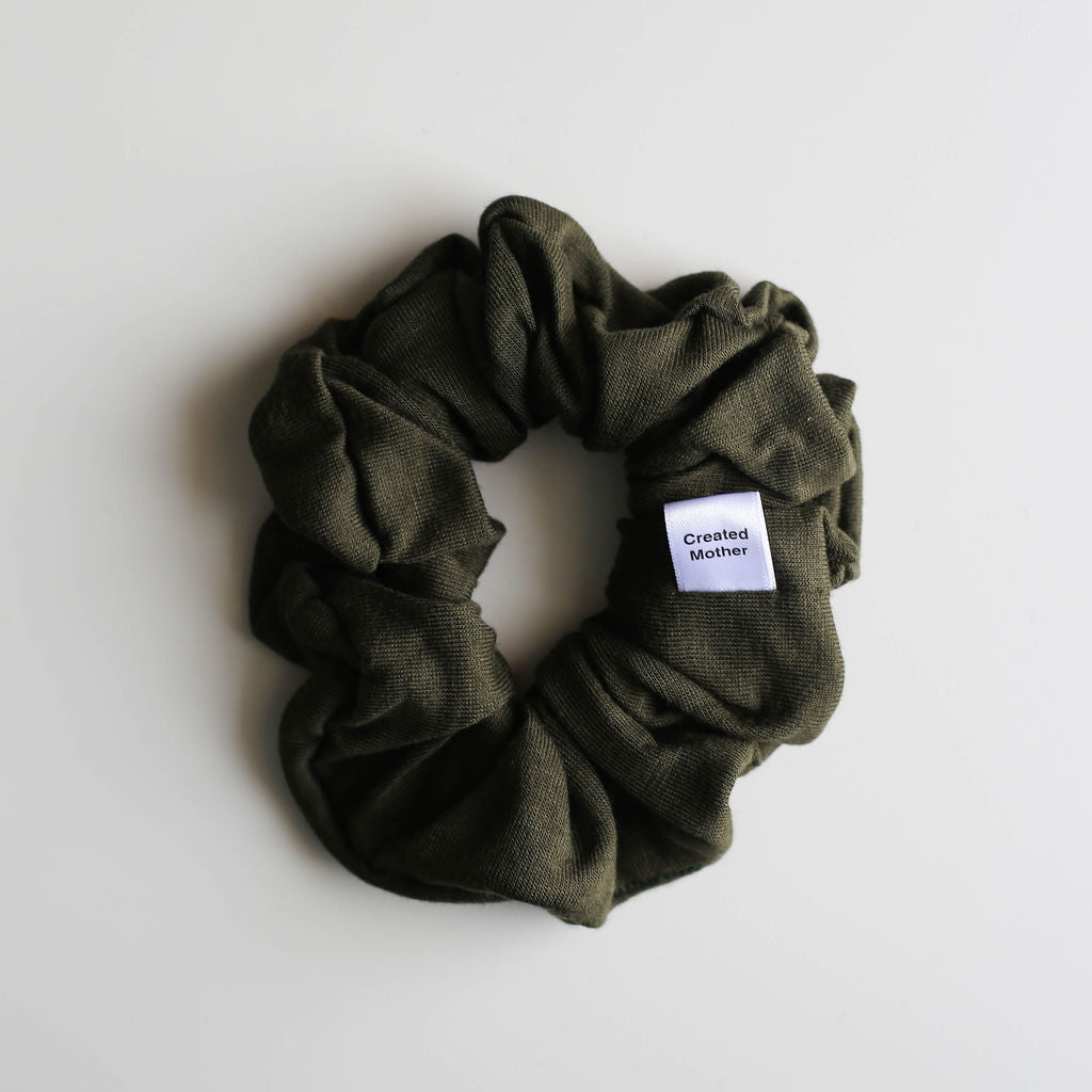 Green scrunchie with a label on a white background