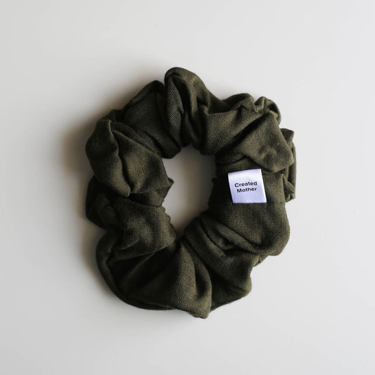 Green scrunchie with a label on a white background