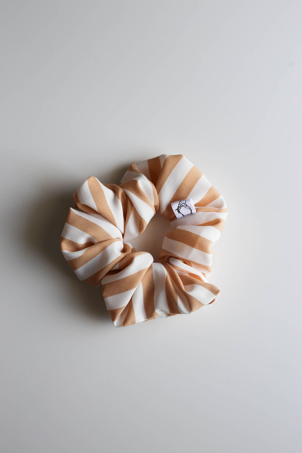 Striped scrunchie on a light gray background