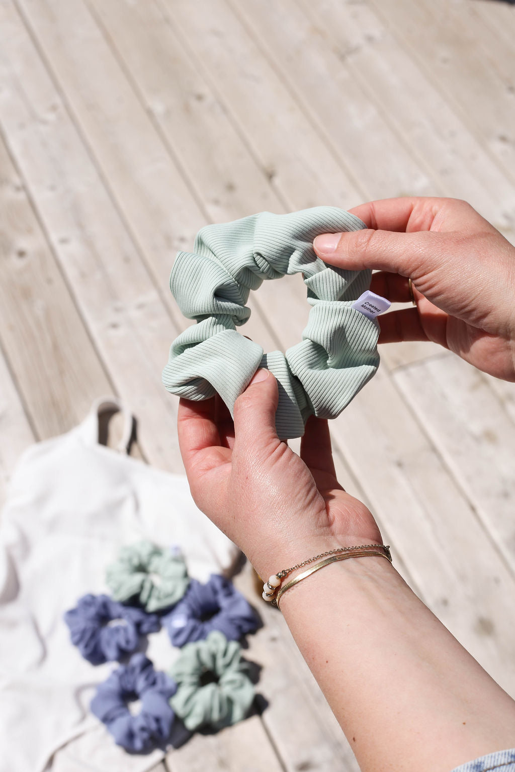 Ribbed texture light sage scrunchie made of spandex and nylon