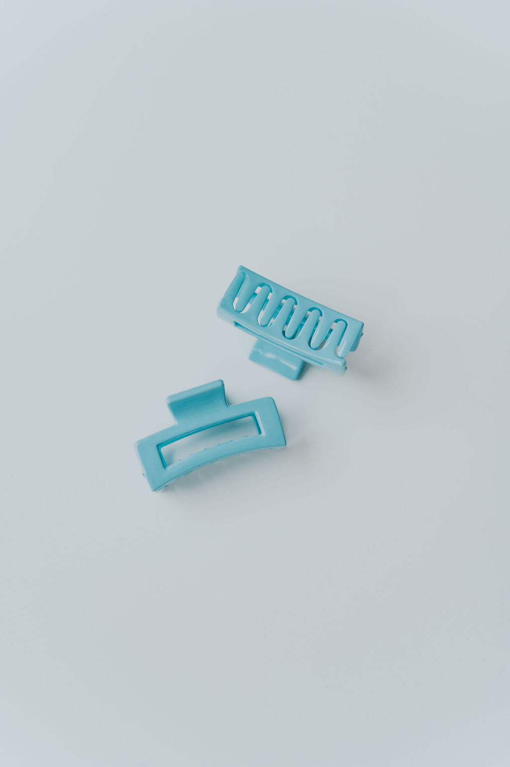 Set of tiny hair claw clips in pastel colors, suitable for fine hair types.
