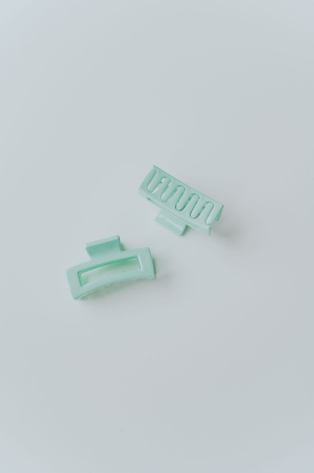 Various small hair accessories in pastel shades, perfect for securing hair strands.