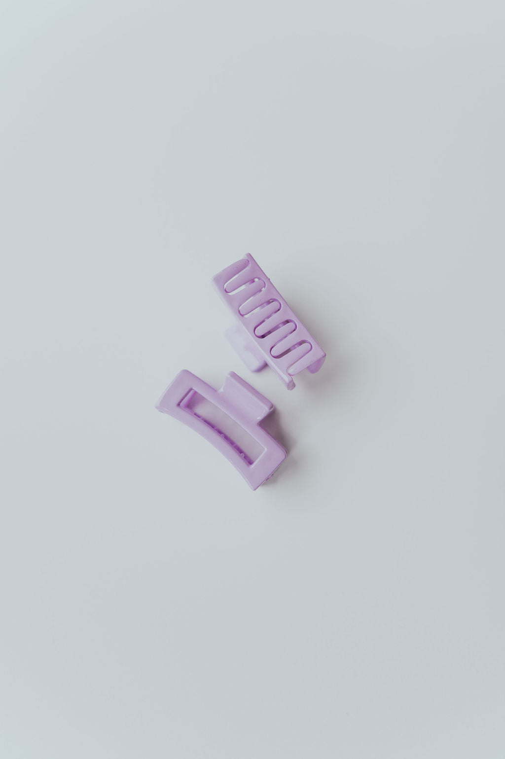 Pastel hair accessories for adults and children, in small rectangle shapes.