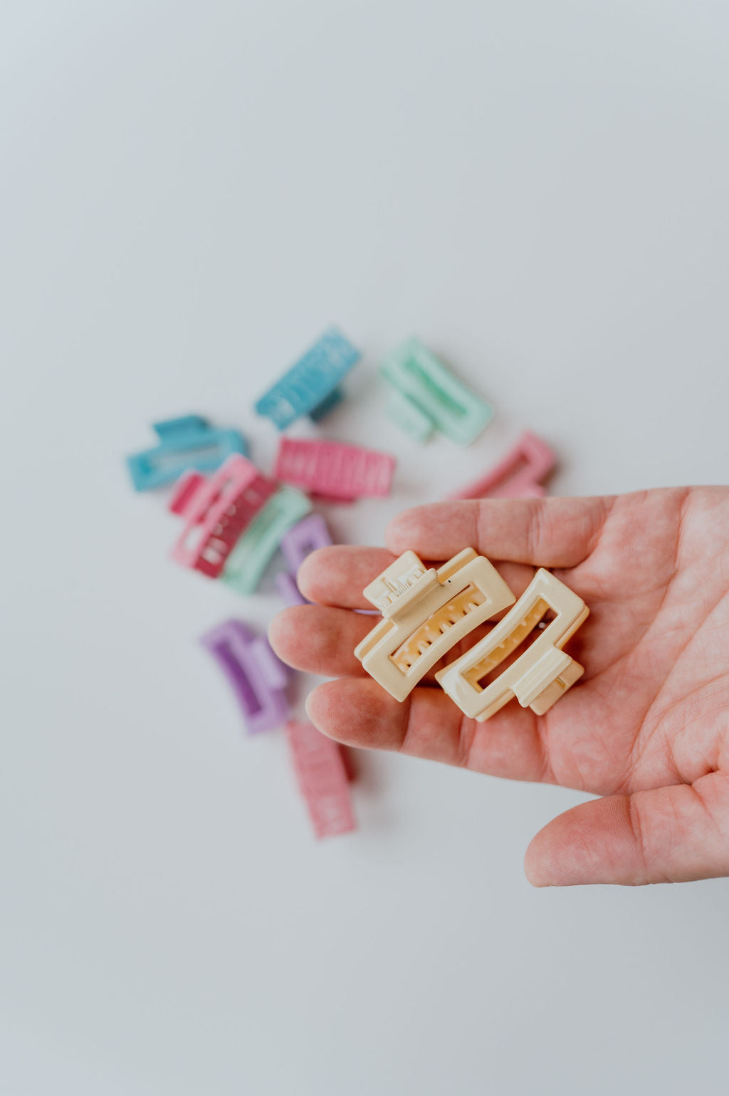Collection of mini hair claws in pastel hues, ideal for adults and kids.