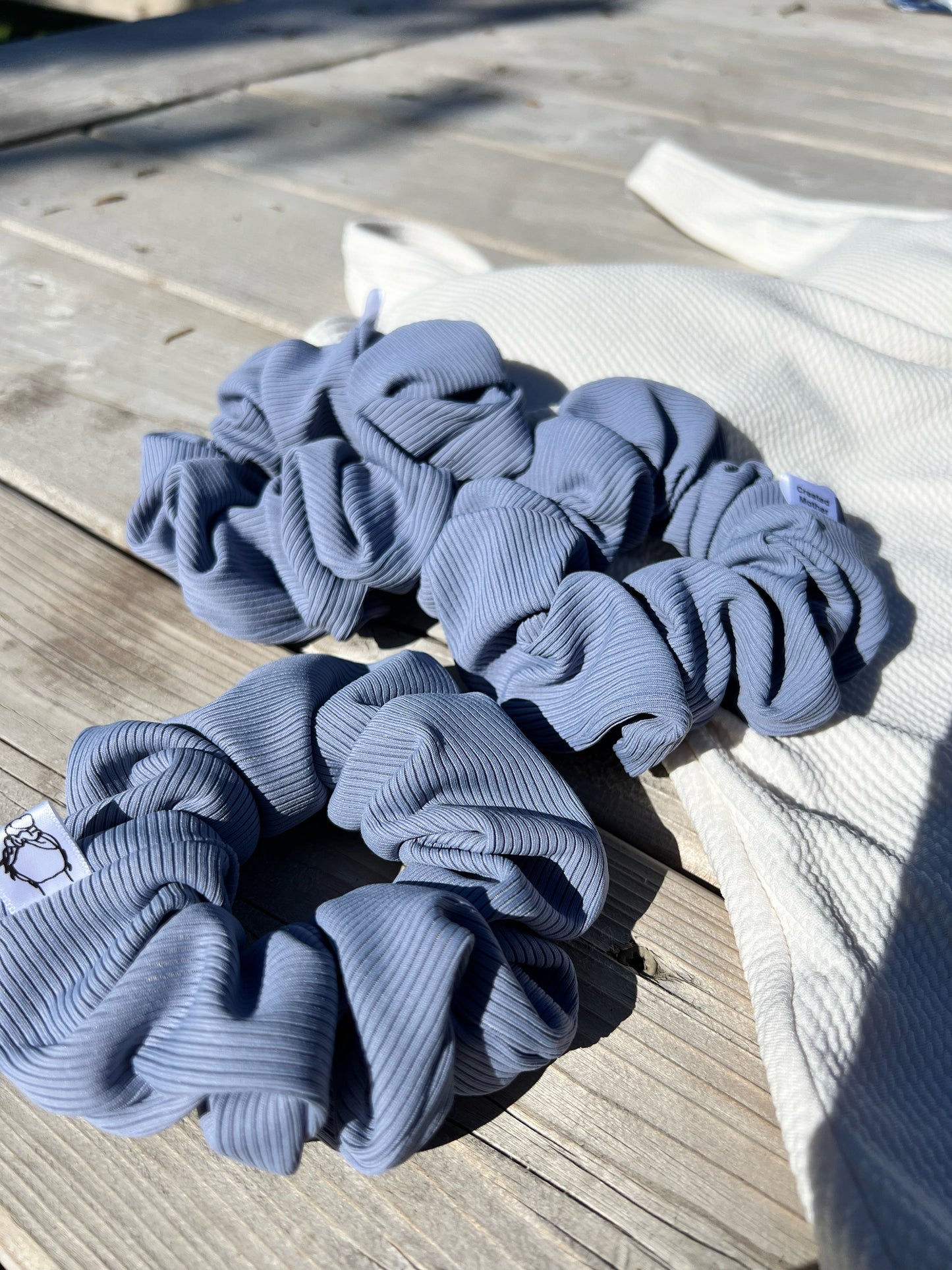 Periwinkle blue SWIM scrunchie with a soft and comfortable ribbed texture.