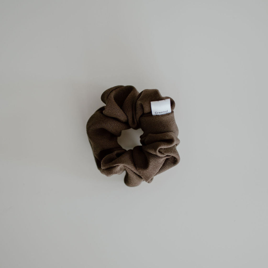 Brown scrunchie on a light gray background