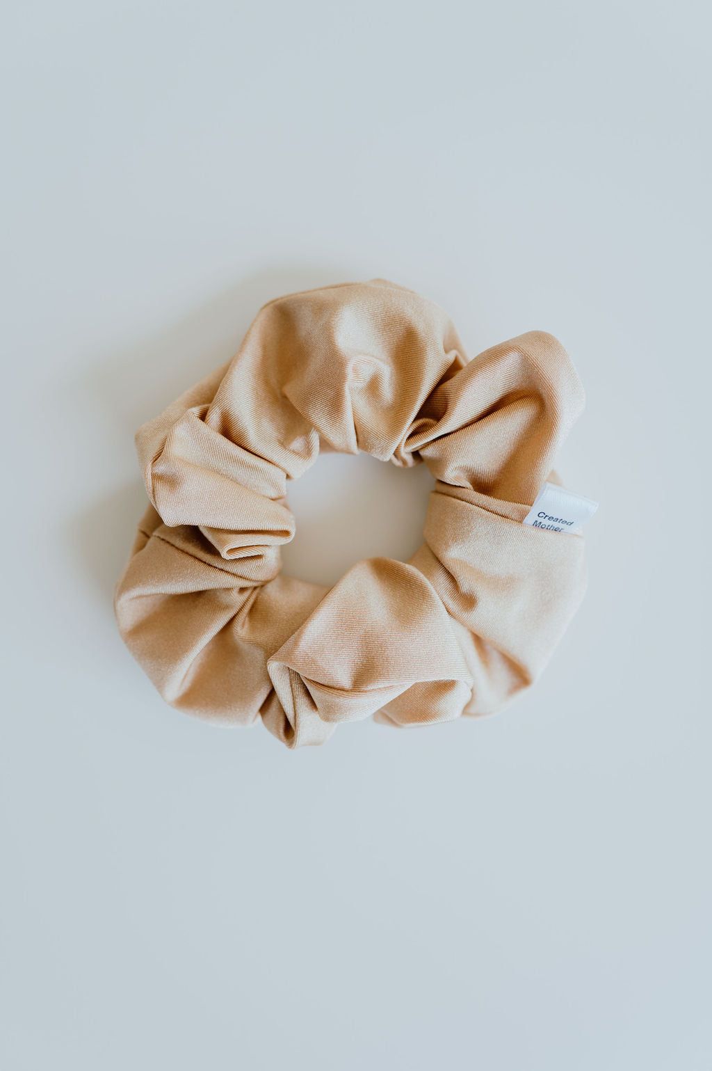 Shimmering gold swim scrunchie with secure hold