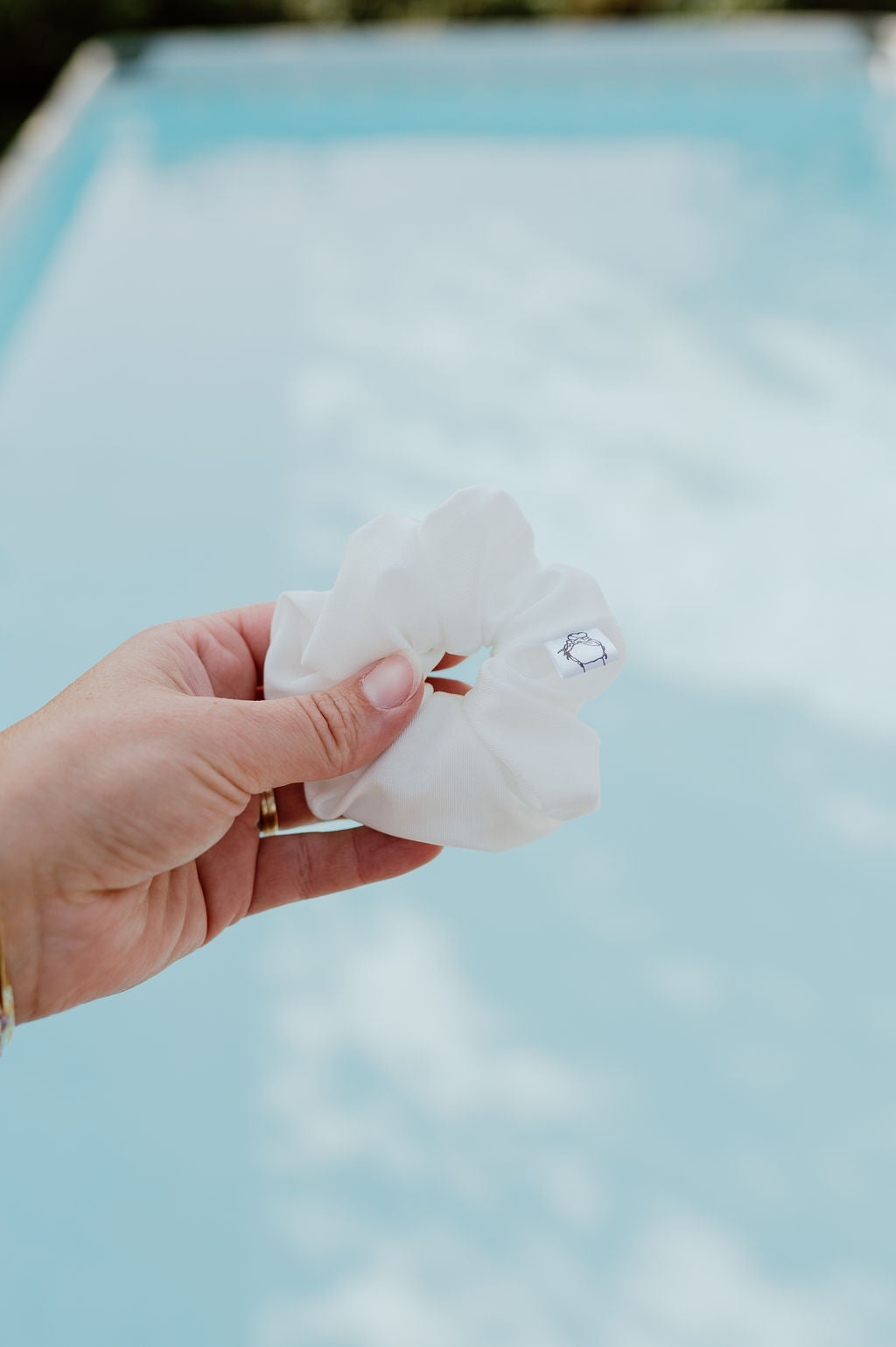 White scrunchie ideal for hiking, gym, and swimming