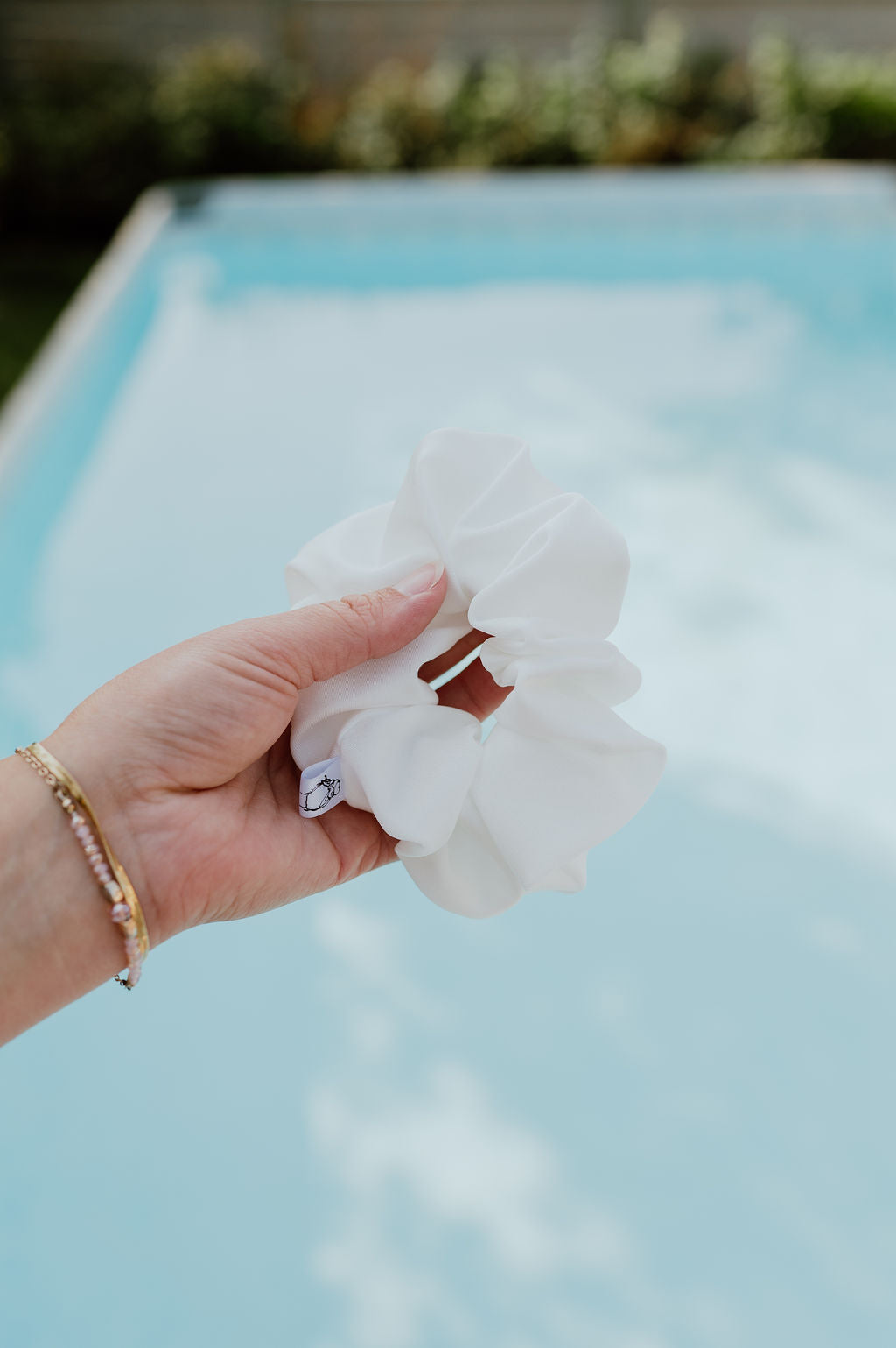 Elegant white swim scrunchie holding hair securely