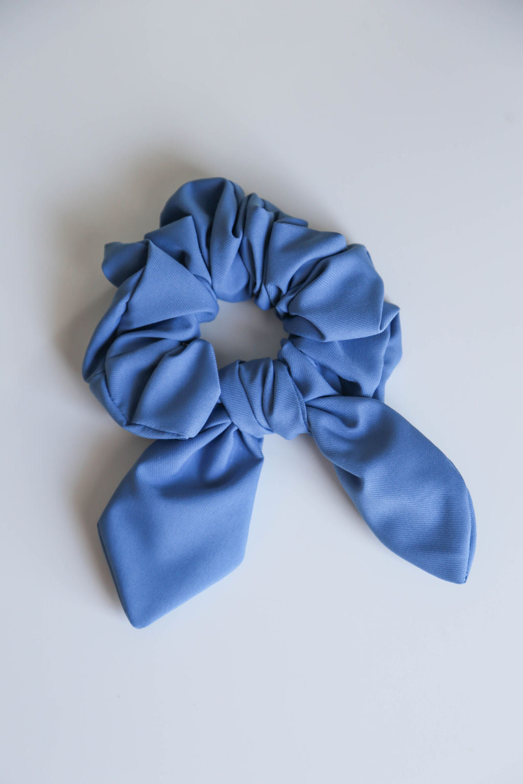 Elegant blue scrunchie with a textured finish, perfect for casual and polished hairstyles.