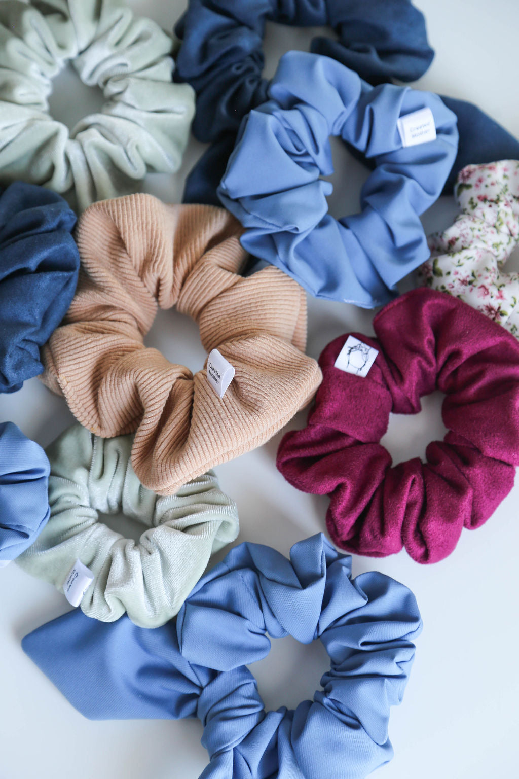 Handcrafted berry suede scrunchie with gentle texture, perfect for adding a pop of color to any hairstyle.