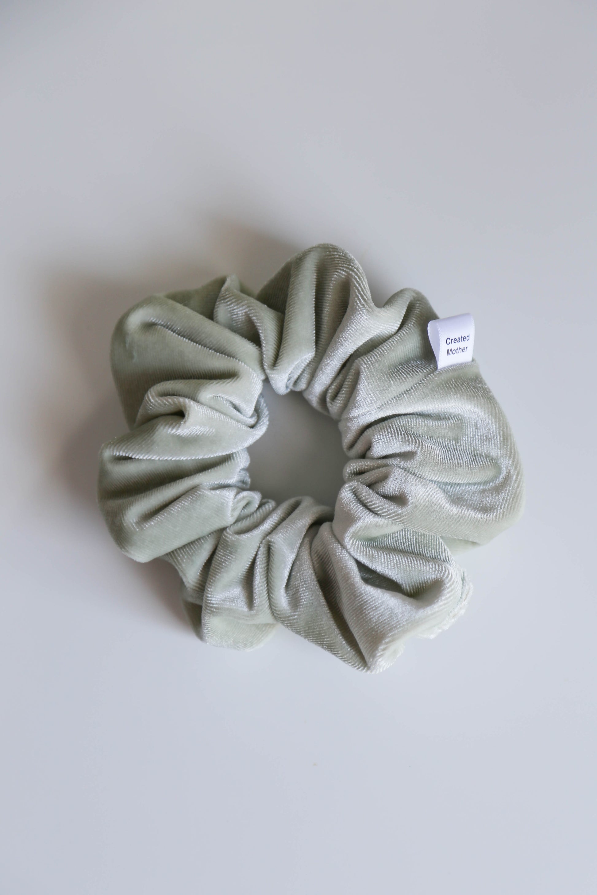 The Eucalyptus Dream Velvet Scrunchie: a locally handmade hair accessory with a rich, luxurious finish.