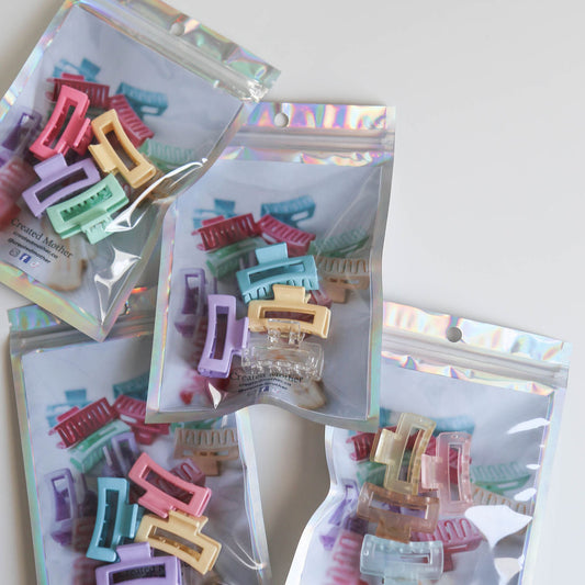 Soft yellow, light blue, and gentle orange claw clips for whimsical hairstyles.