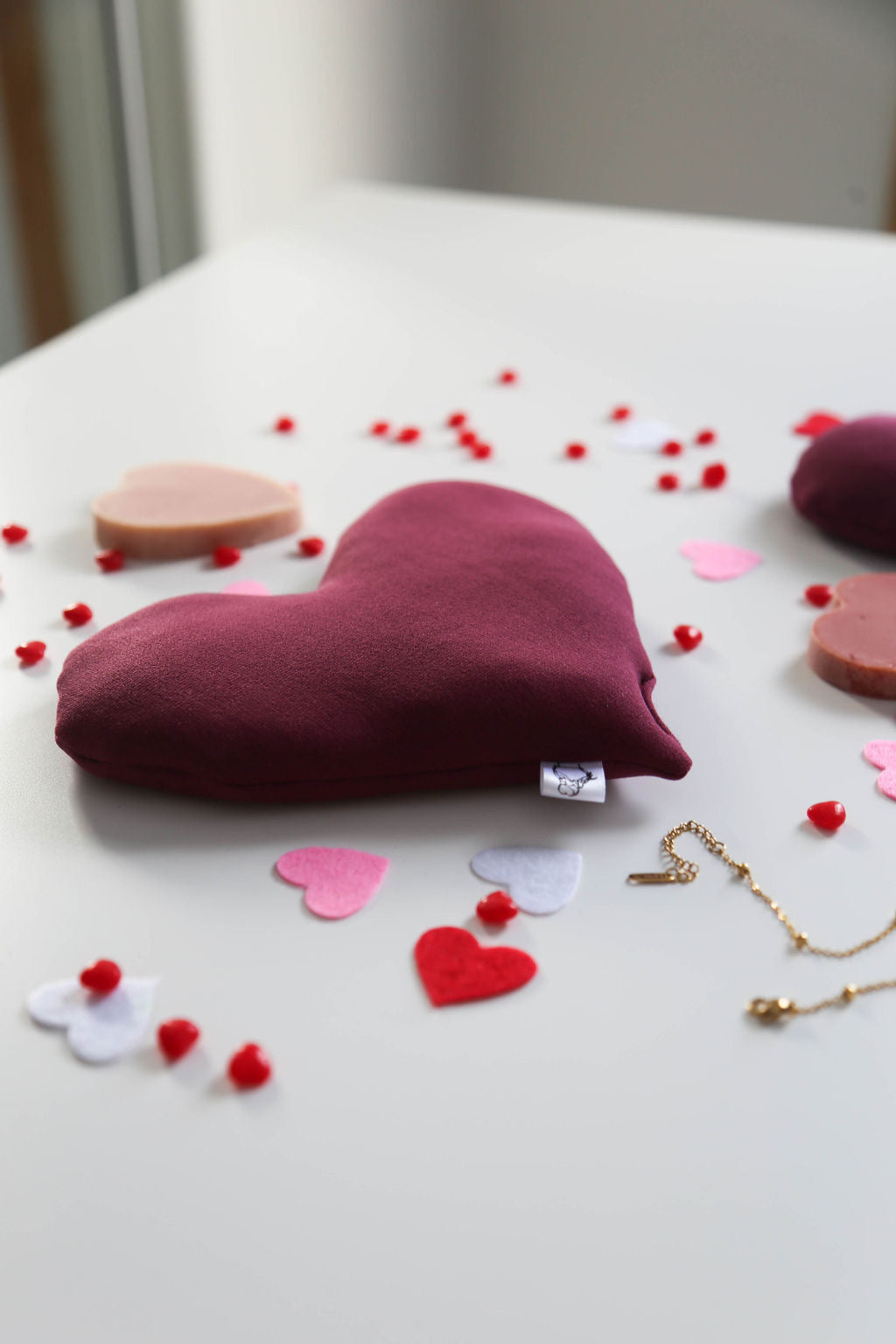 A red heart-shaped hot/cold therapy pack designed to bring love, warmth, and relaxation.