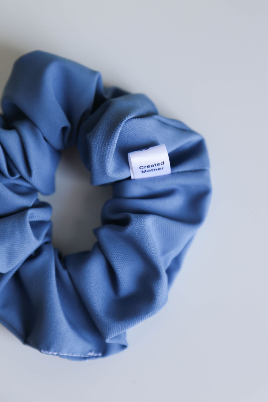 Close-up of the Blue Nova Scrunchie, featuring refined texture and a cool blue hue.