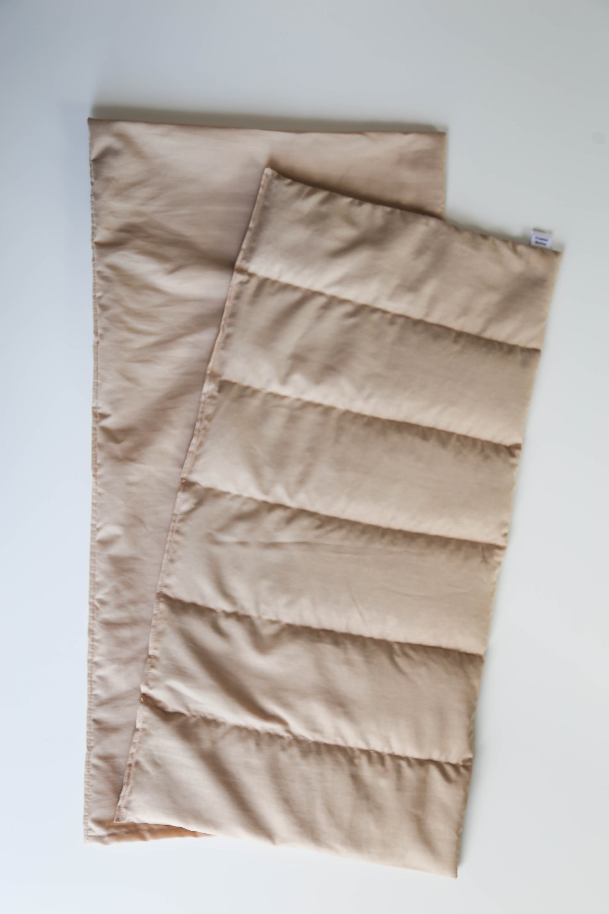 Taupe extra large hot/cold pack for natural pain relief, ideal for adult use on the back, hips, or legs.