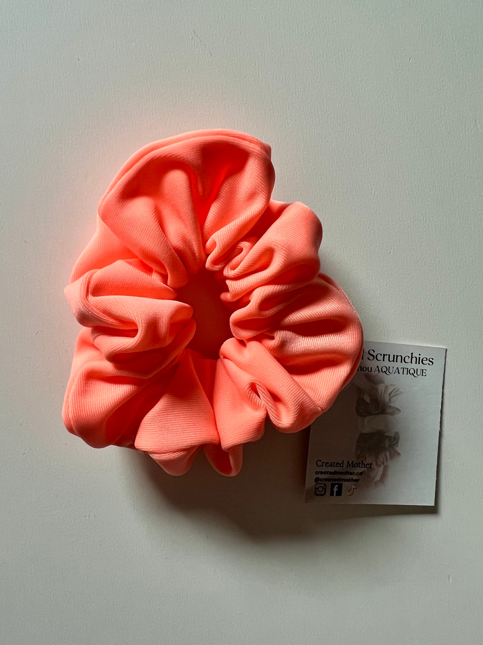 Water-resistant neon peach scrunchie for pool and gym