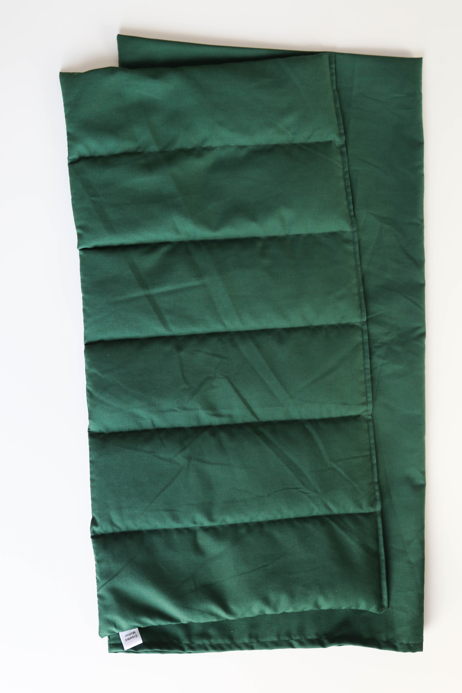 Dark green XL temperature therapy pack for anxiety support and postpartum comfort, with soft matching cover.