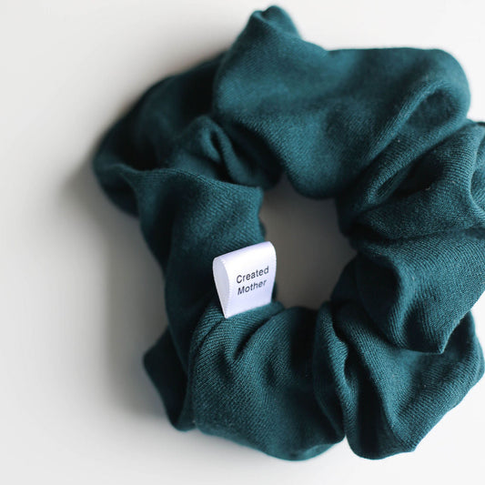 Green scrunchie with a label on a white background