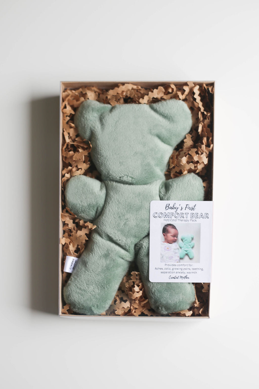 Soft, bear-shaped hot/cold therapy pack for babies, displayed in a premium gift box.