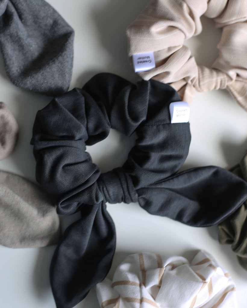 Collection of various colored scrunchies on a light background
