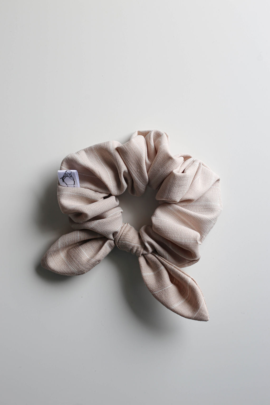 Neutral beige tan scrunchie with a bow by Created Mother