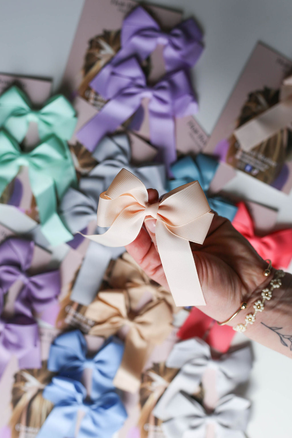 Peach-toned oversized bow clip featured in gift-ready packaging for special occasions.