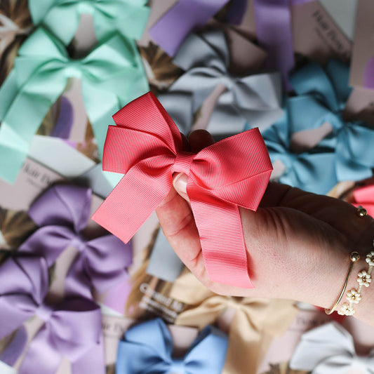 High-quality ribbon bow measuring 3.5” x 4” with durable metal alligator clip backing.