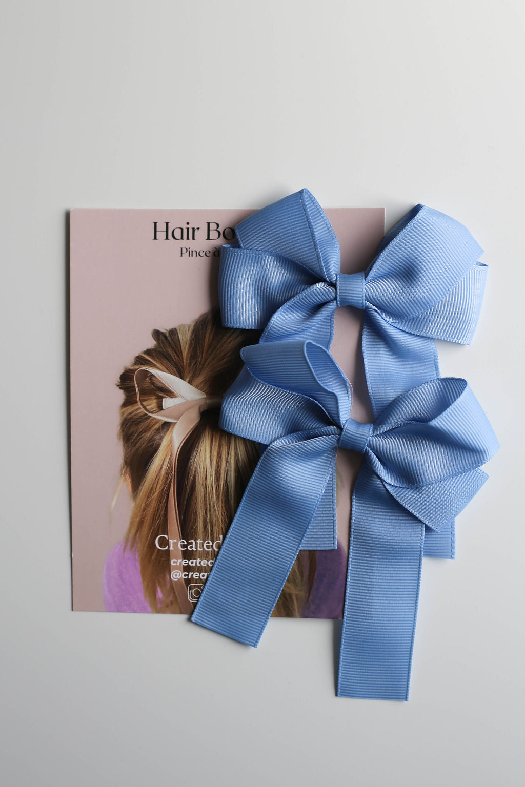 Versatile ribbon bow clip in soft blue, great for kids, teens, and adults.
